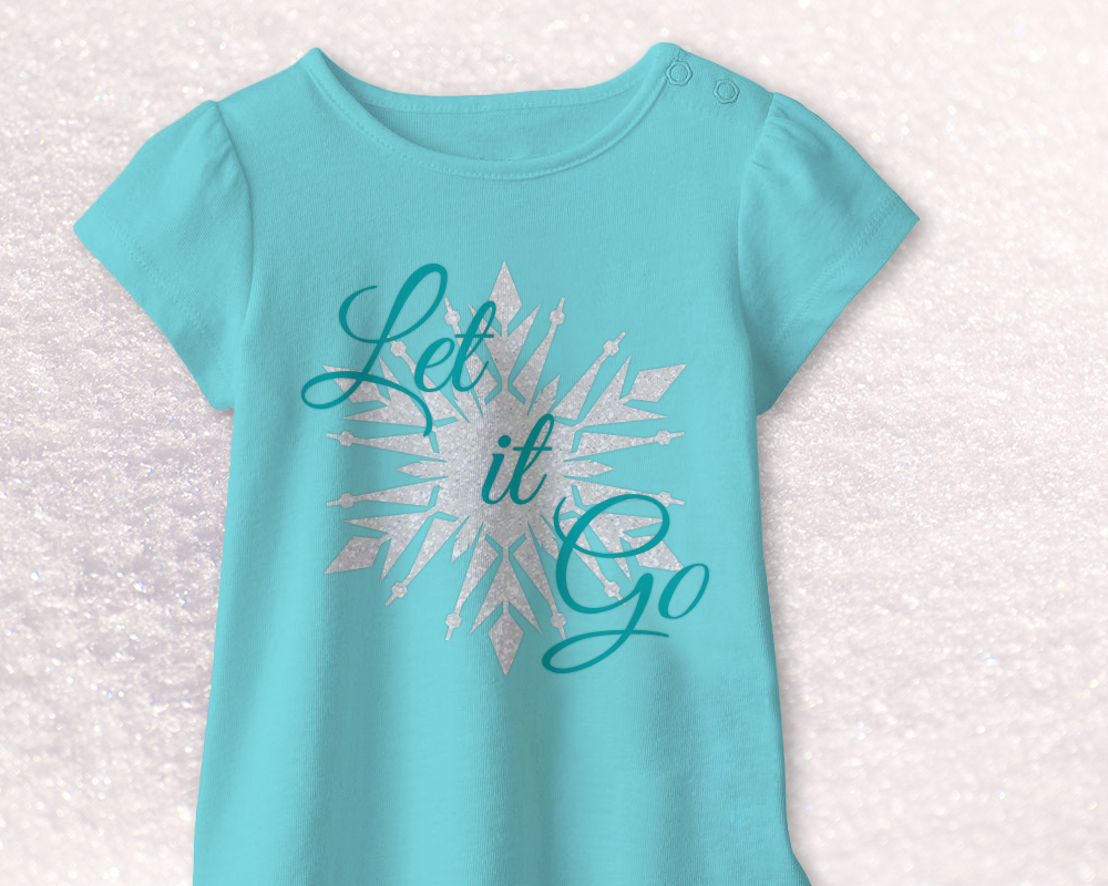Shirt with a silver snowflake design and the text "Let it Go" on top in turquoise.