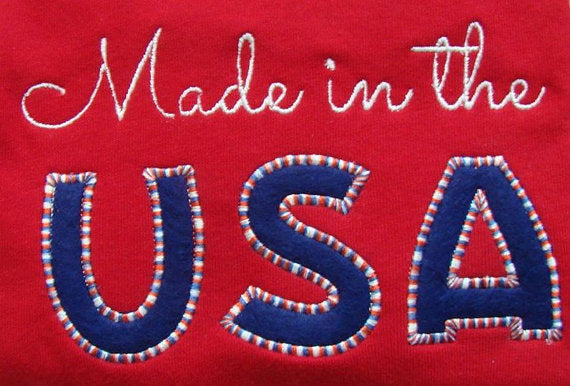 Folded shirt with applique that says "Made in the USA"