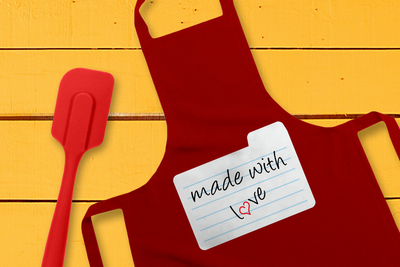 Apron with a recipe card design. The card says "made with love" and a heart is in place of the O.