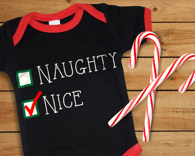 Baby onesie that says "Naughty" and "Nice" and nice is checked off.