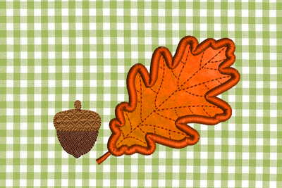 An embroidered acorn with textured top and an applique oak leaf.