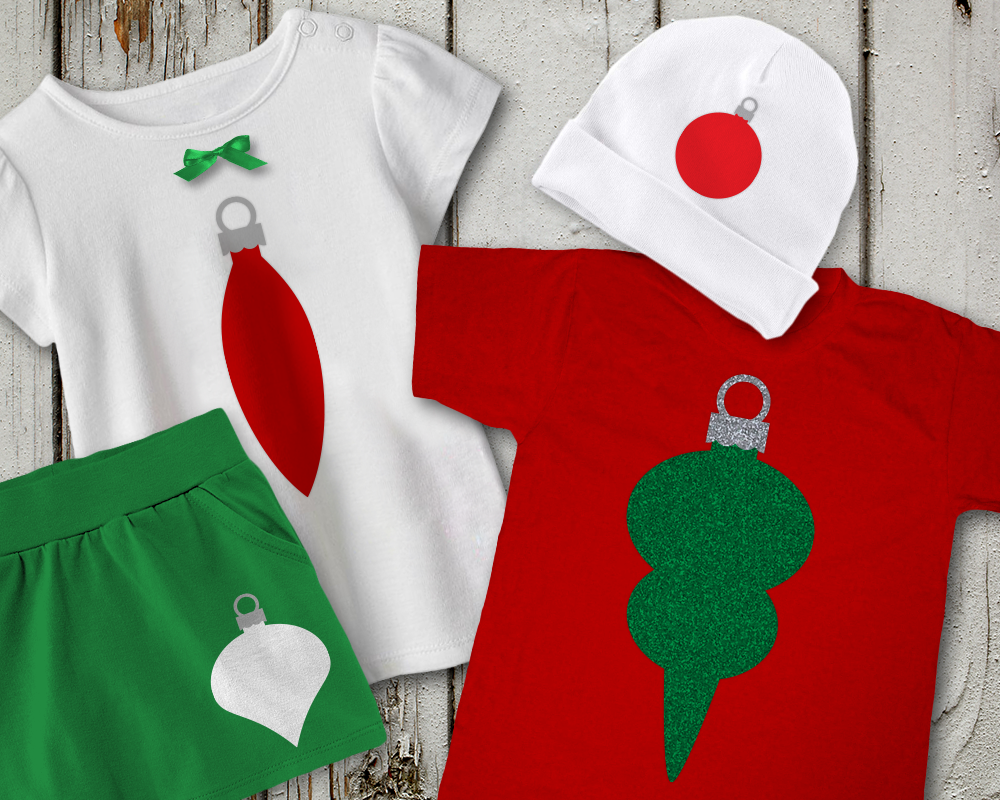 Four different articles of baby clothes in Christmas colors. Each has a different style ornament shape, also in Christmas colors.