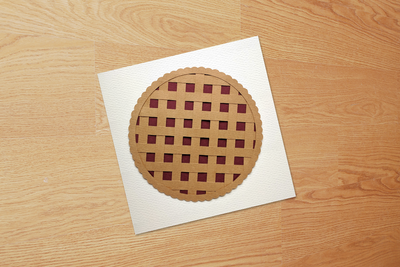 White card with a paper pie with a lattice crust.