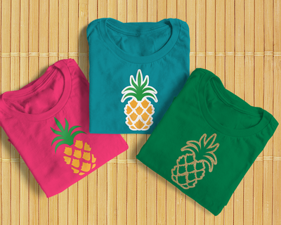 Three folded tees, each with a pineapple design.