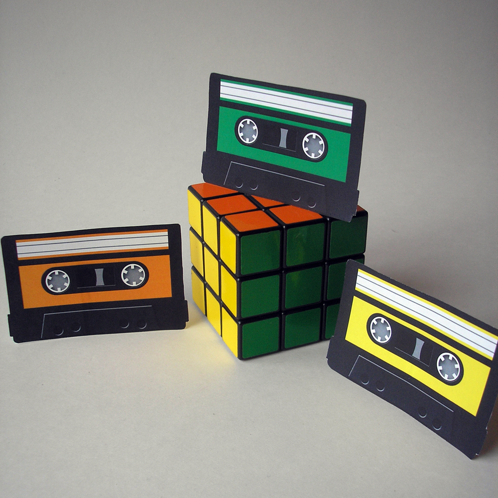 Three cut out paper mix tapes on stands