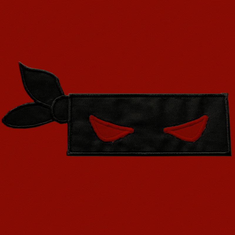 Black blindfold mask applique with red eyes.