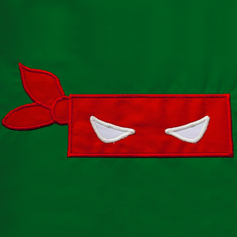 Red blindfold mask applique on a green background.