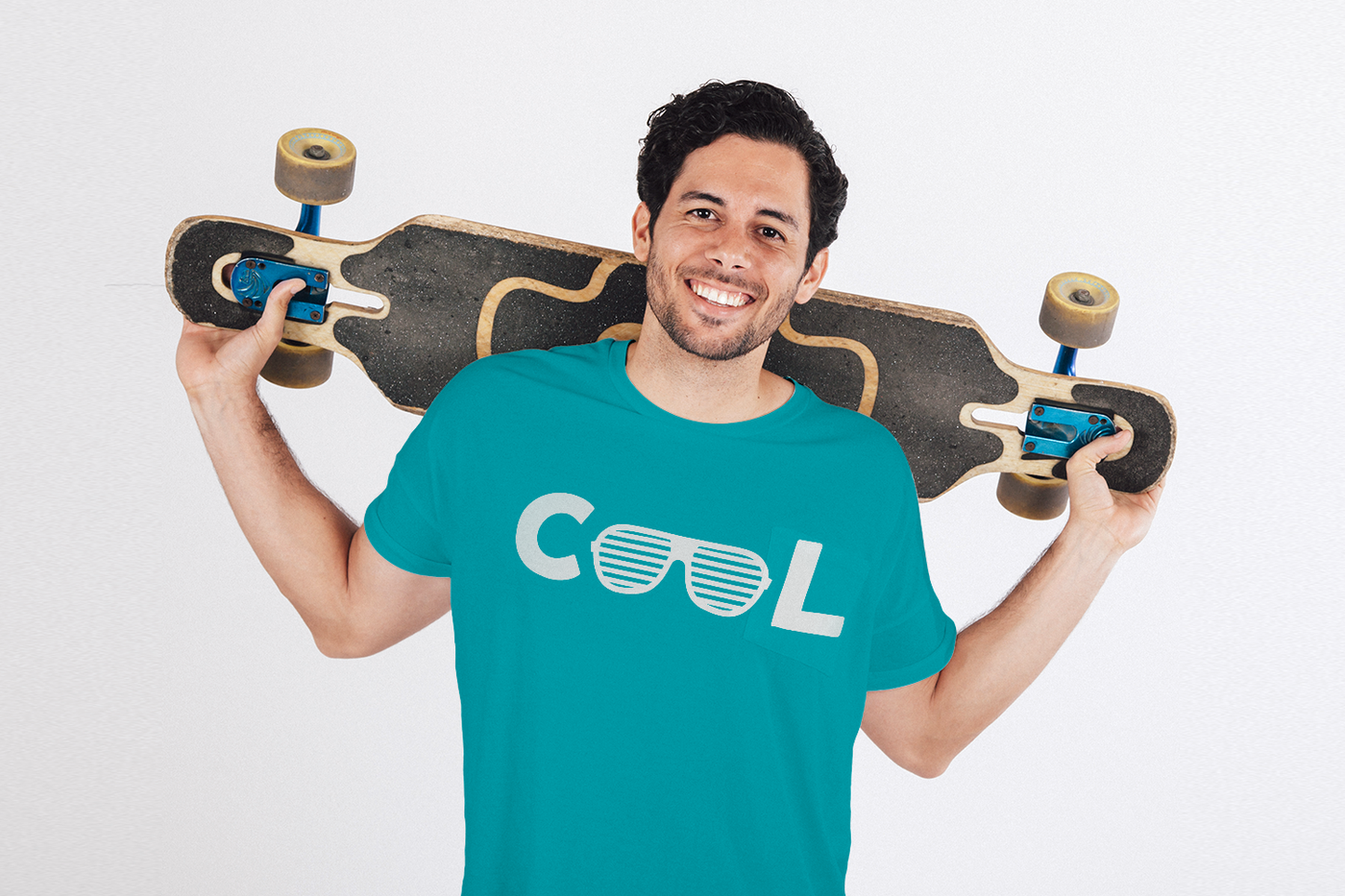 Smiling white man with a skateboard wears a shirt that says "Cool." The Os are a pair of shutter shades.