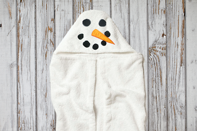 Snowman face applique design on a hooded towel