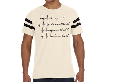 Black man wearing a shirt with 4 different heartbeats that end in a word. The words are sports, basketball, football, and baseball.