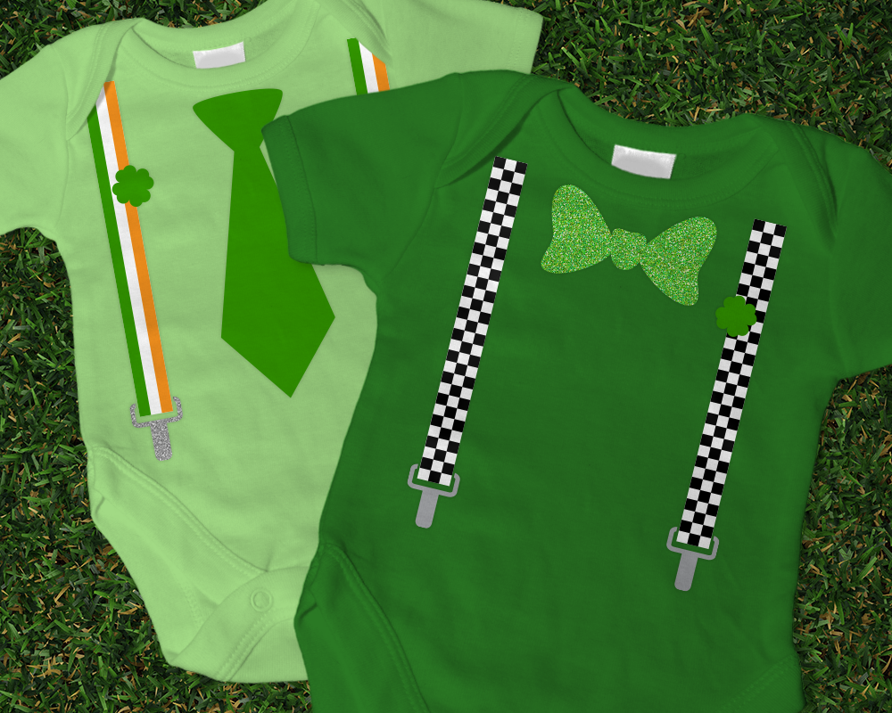 Two green baby onesies. One has a blow tie and checkered suspenders with a shamrock. The other has a neck tie and Irish flag striped suspenders with a shamrock.