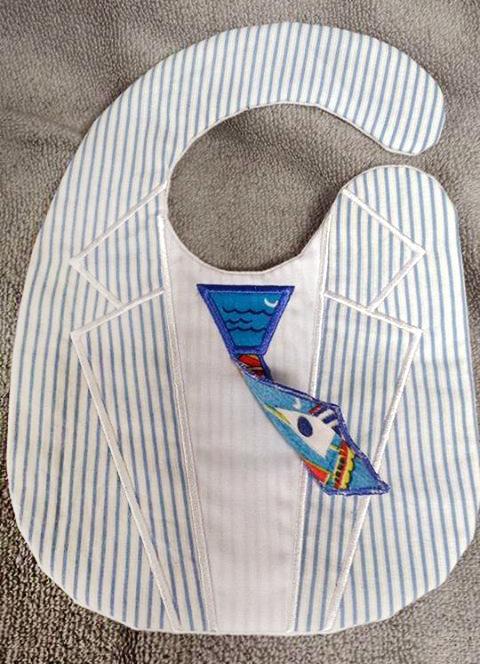 Bib that looks like a suit, with a tie. The tie's tail is flipped up to show this hangs like a real tie.