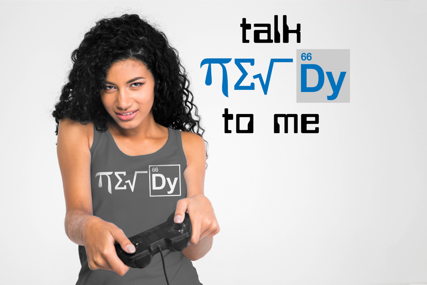 Woman of color holds a video game controller with a determined look. On her tank top it says "NERDY" spelled out of science and math symbols. On the wall behind her it says "talk NERDY to me" with those same symbols for the word "NERDY"