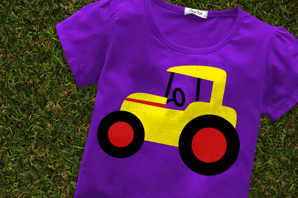 A purple child's shirt with the design of a yellow and red tractor.