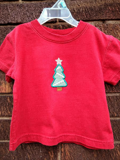 Red child's shirt with an applique Christmas tree.