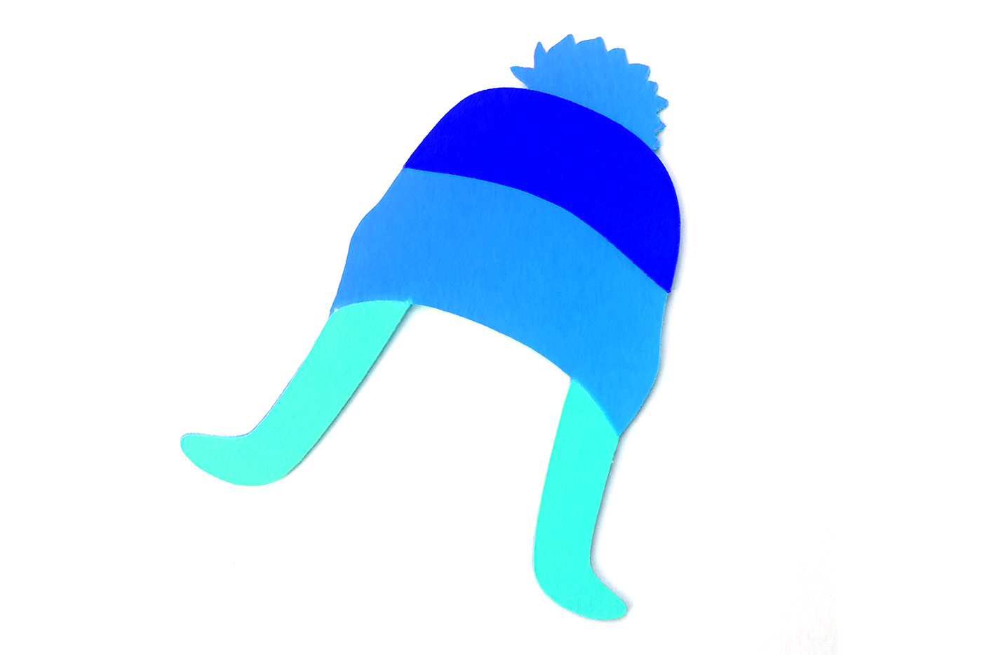 Tri-colored winter hat with flaps and a pom pom made out of paper