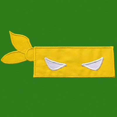 Yellow blindfold mask applique on a green background.