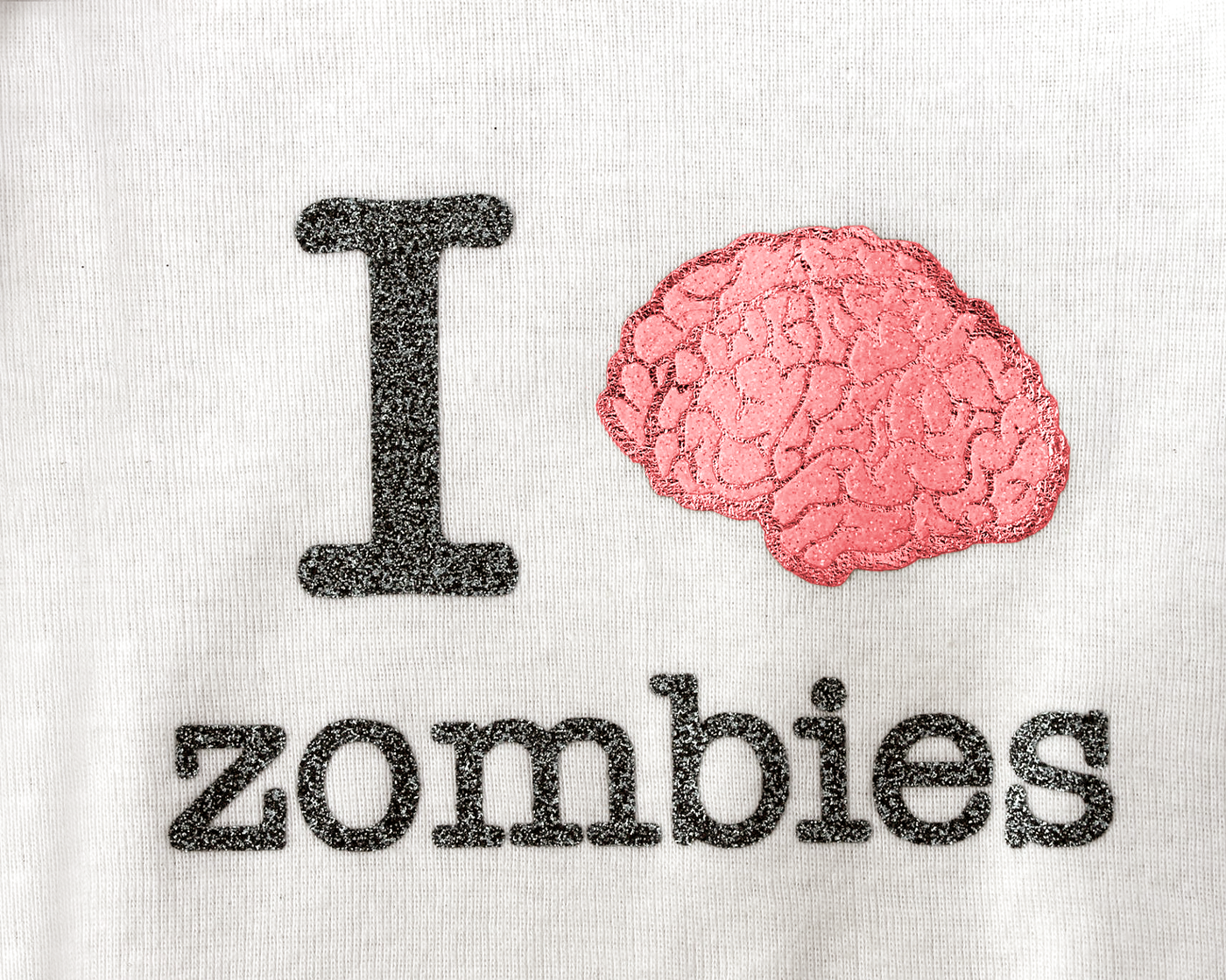 White fabric with a design that has a brain and reads "I [brain image] zombies."